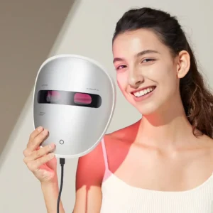 AMIRO Spectra 5-in-1 LED light therapy facial mask held by a smiling woman